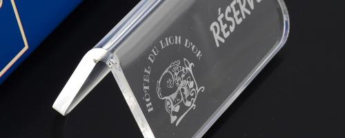 Small signage with a text and logo made with acrylic engraving machine